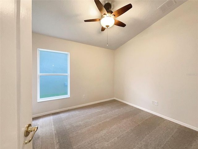 carpeted spare room featuring ceiling fan and lofted ceiling