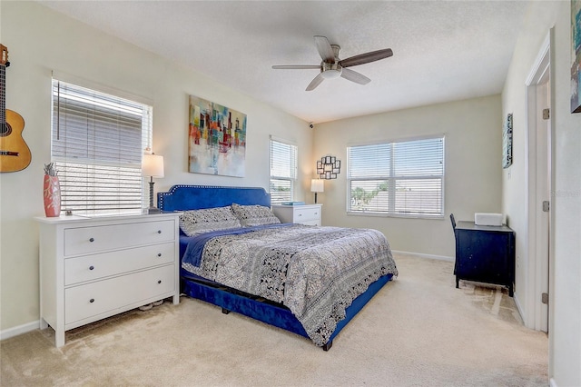 bedroom with light carpet and ceiling fan