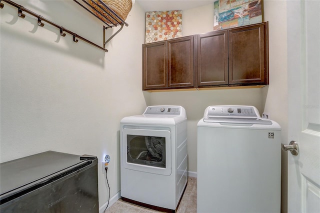 laundry room featuring cabinets and separate washer and dryer