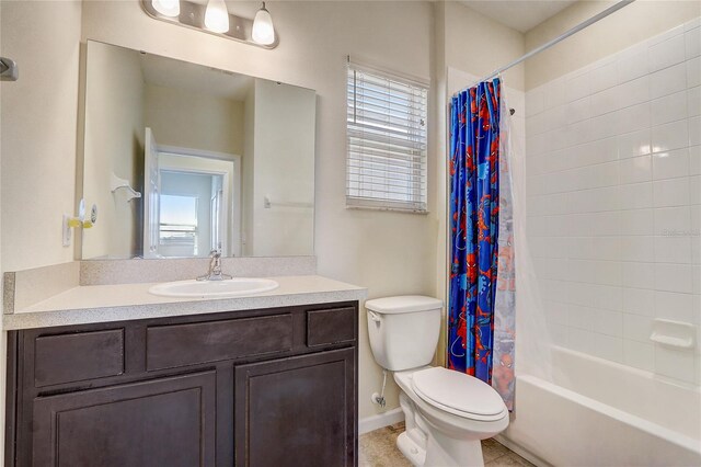 full bathroom featuring shower / tub combo, vanity, toilet, and tile patterned floors