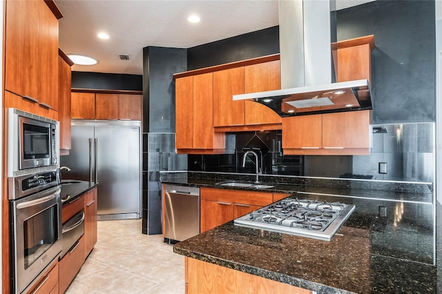 kitchen featuring tasteful backsplash, sink, dark stone counters, built in appliances, and extractor fan