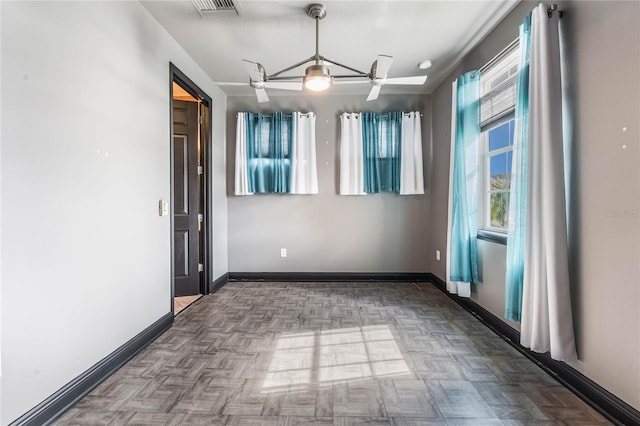 spare room featuring parquet flooring and ceiling fan