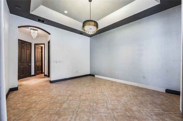 empty room with light tile patterned flooring and a textured ceiling