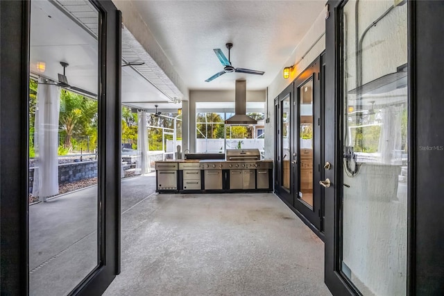 sunroom featuring ceiling fan