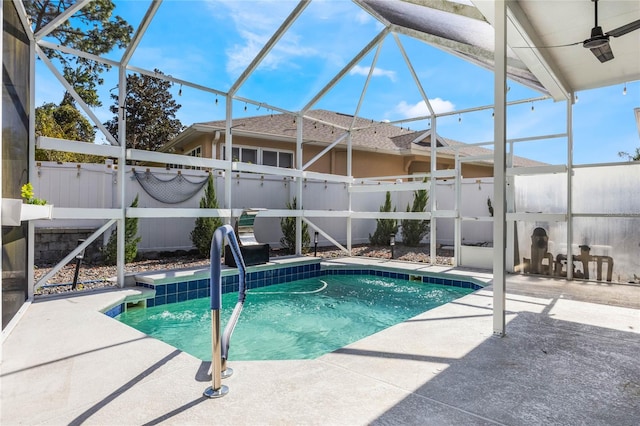 view of swimming pool featuring a patio area and glass enclosure