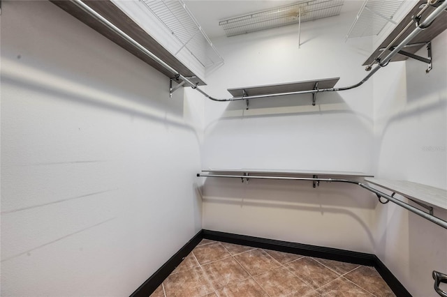 spacious closet with tile patterned floors