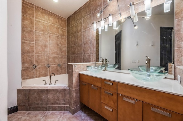 bathroom featuring double vanity, a sink, a bath, and tile walls