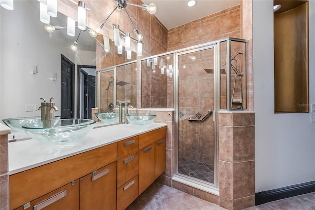 full bath with double vanity, a sink, and a shower stall