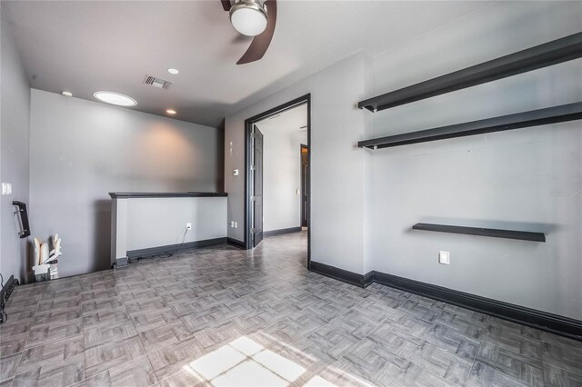 unfurnished room with visible vents, ceiling fan, and baseboards