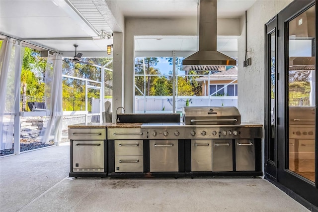 view of patio with area for grilling, an outdoor kitchen, and a sink