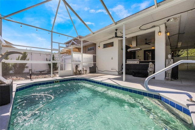 outdoor pool with a lanai, ceiling fan, and a patio