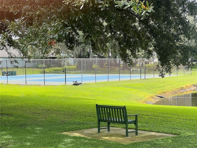 surrounding community featuring a yard and tennis court