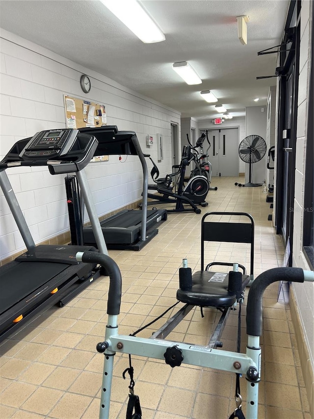 workout area featuring a textured ceiling