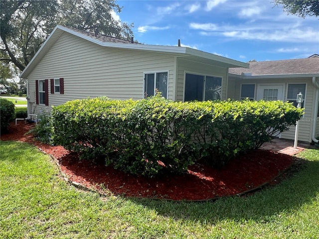 view of home's exterior with a yard