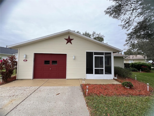 view of front facade featuring a garage and a sunroom