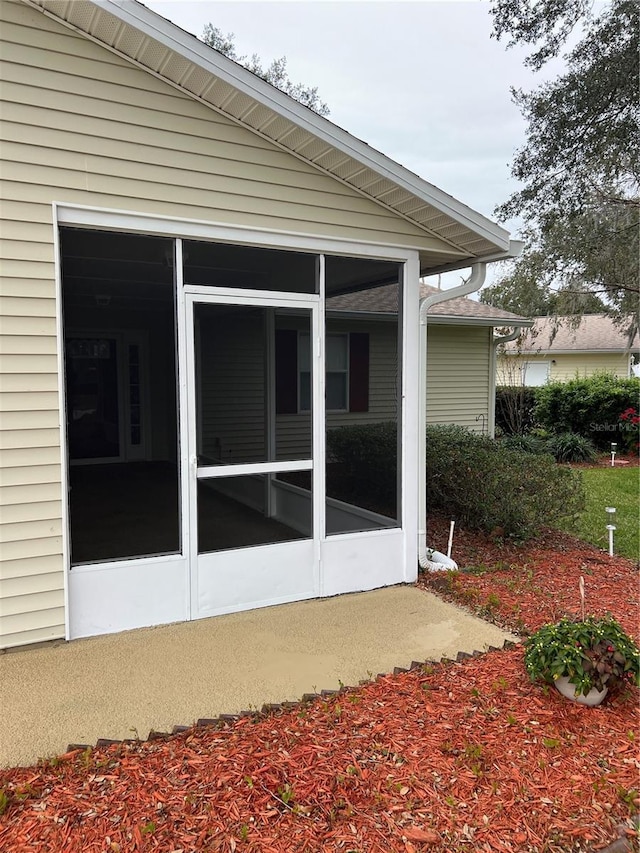 view of property exterior featuring a sunroom