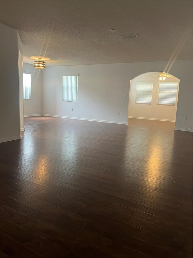 empty room featuring dark hardwood / wood-style floors and a textured ceiling