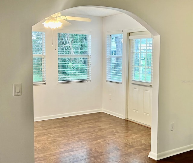 spare room featuring ceiling fan and dark hardwood / wood-style floors