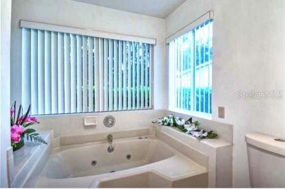 bathroom featuring a bathing tub and toilet