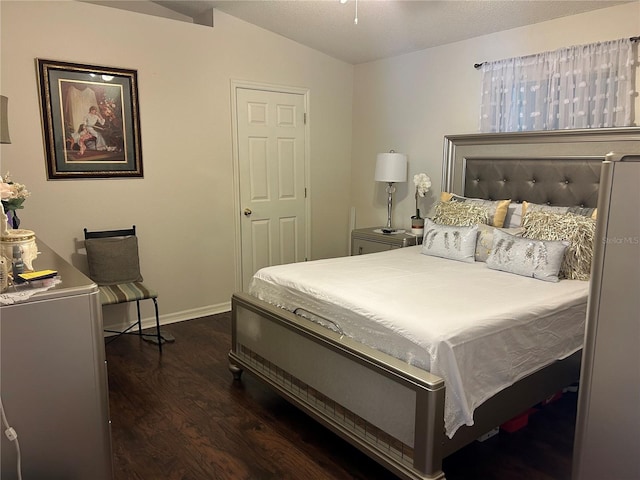 bedroom featuring vaulted ceiling and dark wood-type flooring