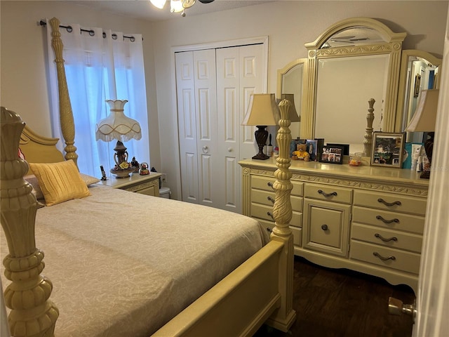 bedroom with dark hardwood / wood-style floors and a closet