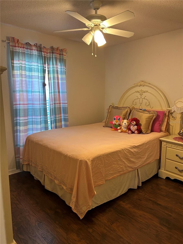 bedroom featuring ceiling fan, a textured ceiling, and dark wood-type flooring