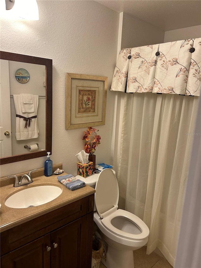 bathroom featuring tile patterned flooring, vanity, toilet, and a shower with shower curtain