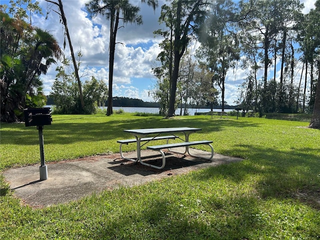 view of community featuring a yard and a water view