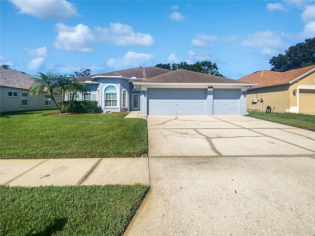 ranch-style house with a garage and a front yard