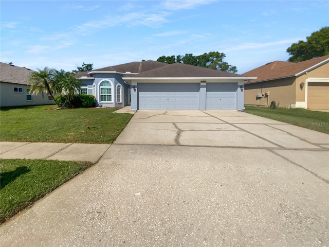 single story home featuring a front lawn, concrete driveway, an attached garage, and stucco siding