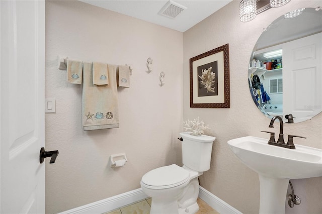 bathroom with sink, toilet, and tile patterned floors