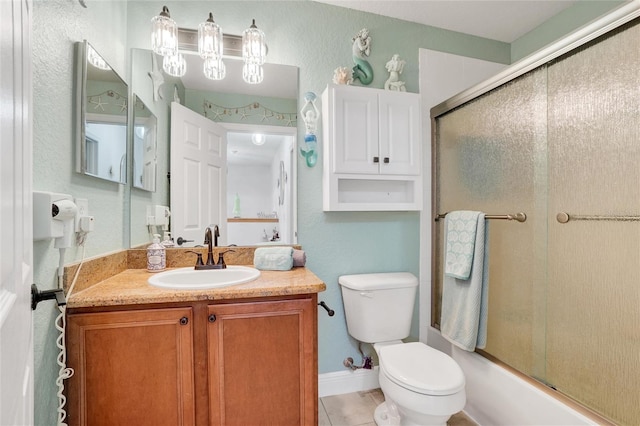 full bathroom featuring shower / bath combination with glass door, vanity, toilet, and tile patterned floors