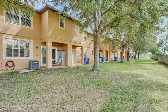 view of yard with central air condition unit and a patio area