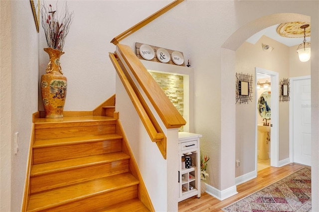 stairs with hardwood / wood-style floors