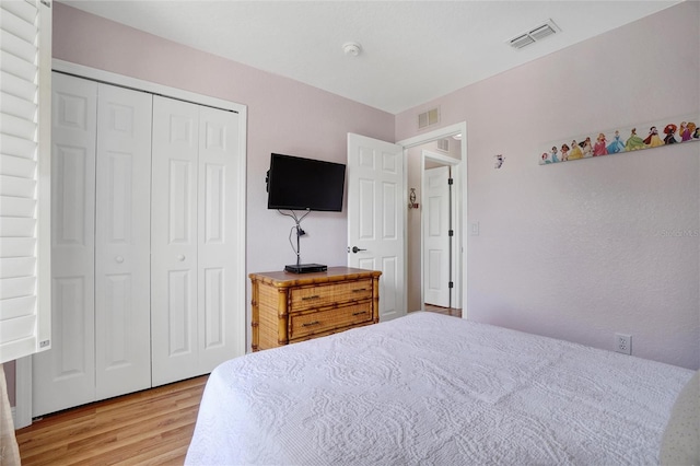 bedroom featuring wood-type flooring and a closet