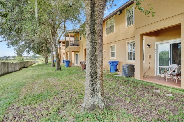 view of yard with a balcony, a patio, and cooling unit