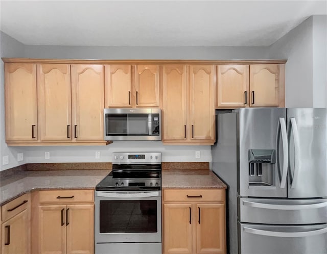 kitchen with appliances with stainless steel finishes and light brown cabinets