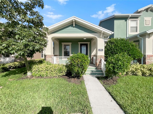 view of front of house with a front lawn and a porch