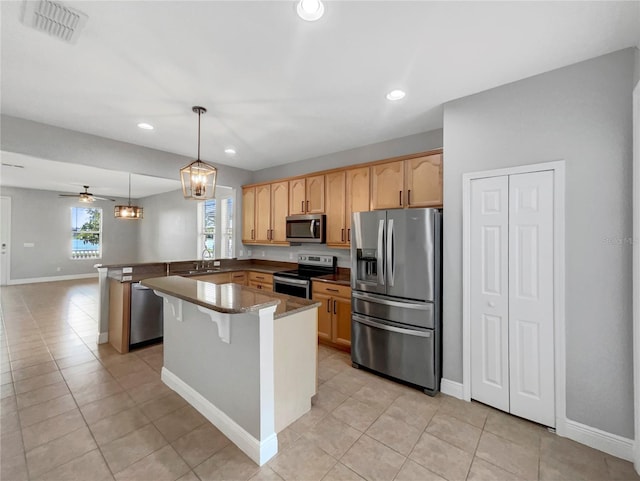 kitchen with ceiling fan, hanging light fixtures, sink, light tile patterned floors, and stainless steel appliances