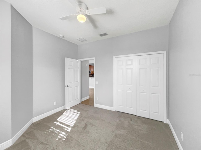 unfurnished bedroom featuring a closet, carpet, and ceiling fan