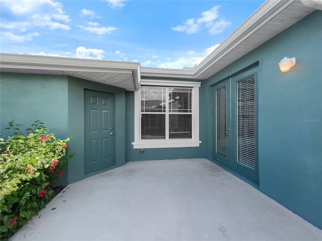 property entrance featuring a patio area