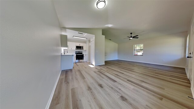 unfurnished living room with lofted ceiling, light hardwood / wood-style floors, and ceiling fan