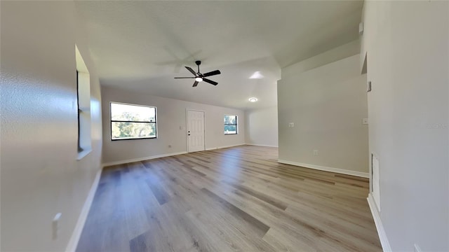 unfurnished living room with light wood-type flooring and ceiling fan