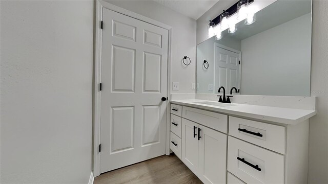 bathroom with vanity and hardwood / wood-style floors