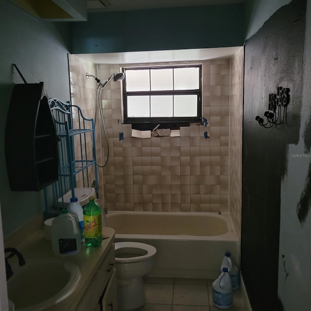 full bathroom with vanity, tiled shower / bath combo, toilet, and tile patterned flooring