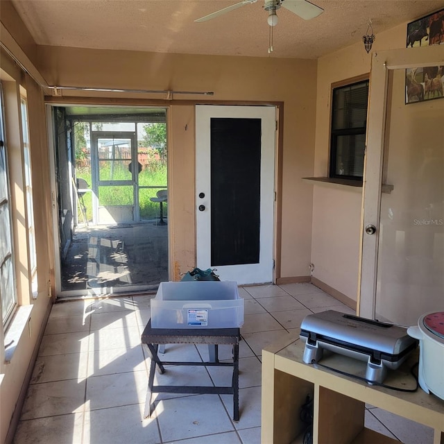 sunroom featuring ceiling fan