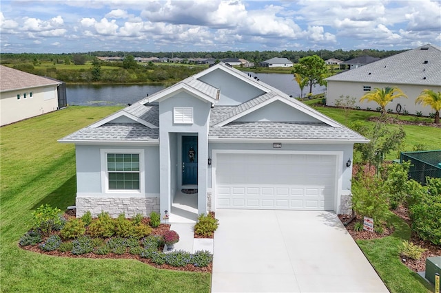 view of front of house featuring a water view, a garage, and a front yard