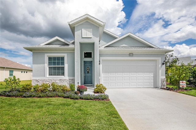 view of front of home with a garage and a front lawn