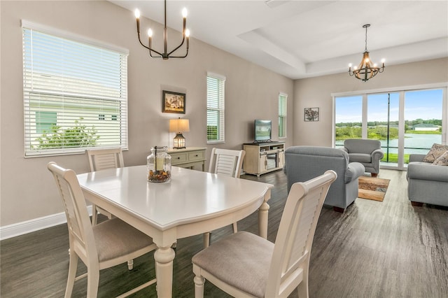 dining area with a notable chandelier and dark wood-type flooring