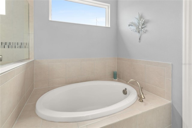 bathroom featuring tiled tub